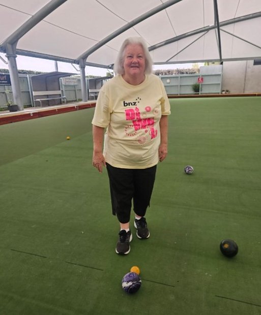 A member playing indoor bowls