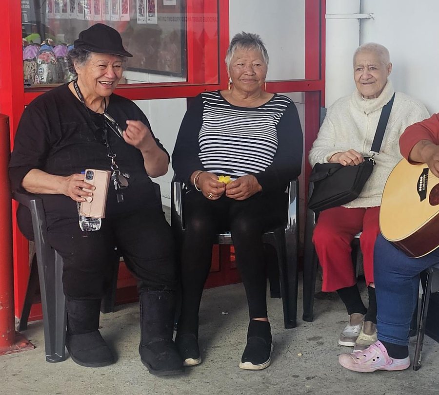 Three members sitting together and laughing